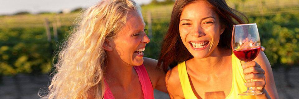 Two women enjoying a glass of wine in a French sunset