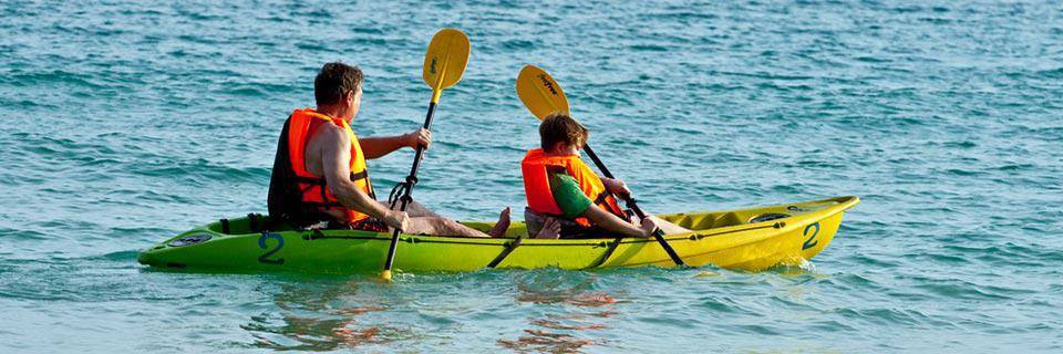 A father and son paddle in a kayak