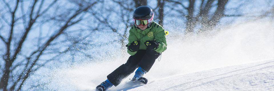 Little boy skiing down a mountain