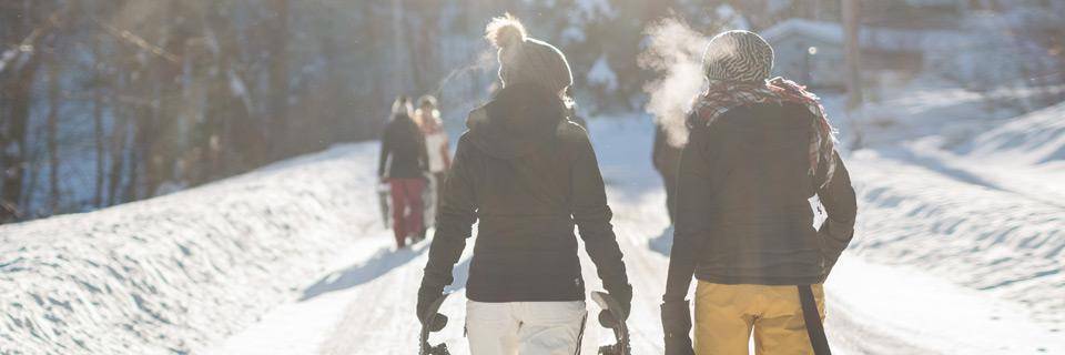 Two women walking home from a day's skiing