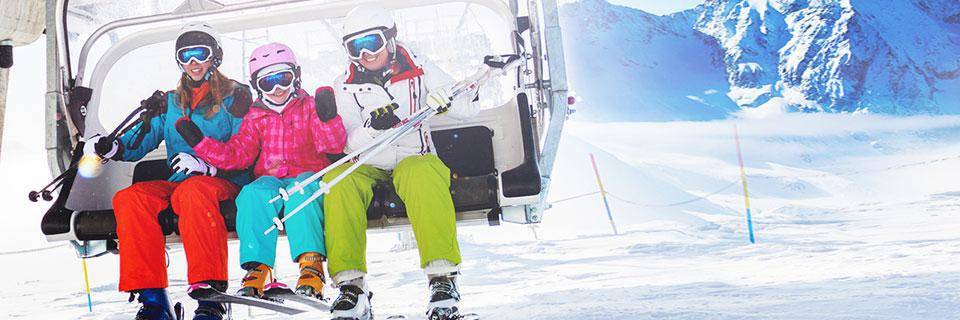 Family sitting on a ski chair lift