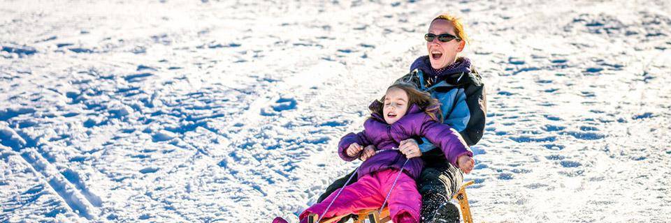 Sliding down a hill on a toboggan