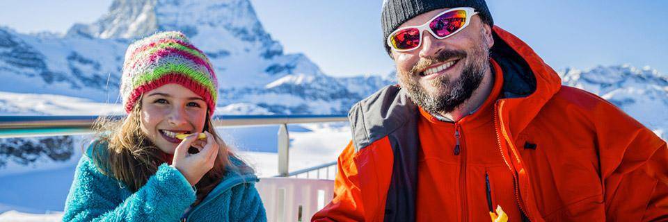 Father and daughter eating on a French Alps ski holiday